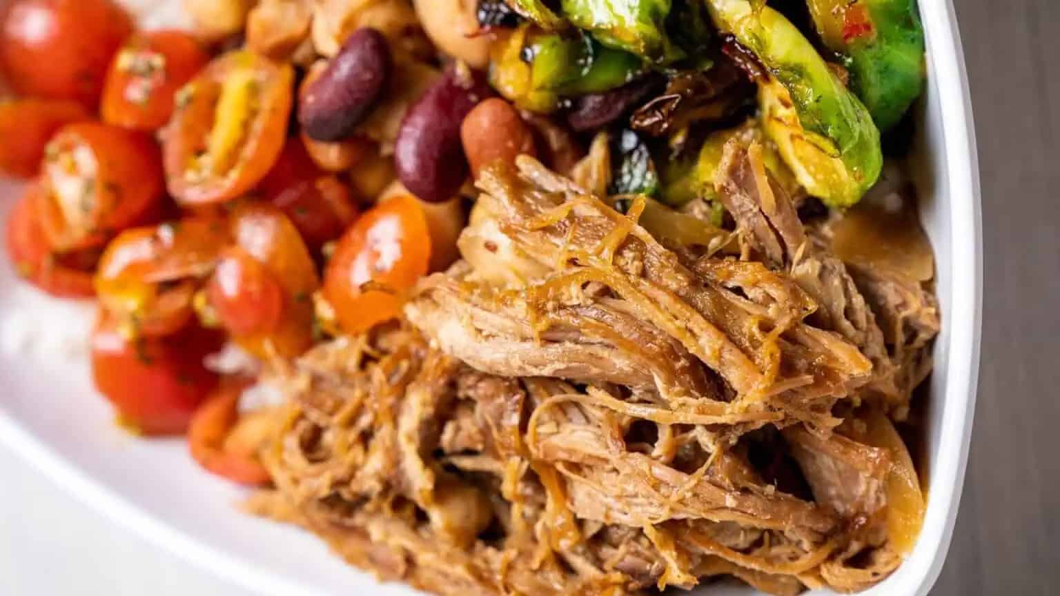 shredded pork, beans, tomatoes, veggies, and more in a bowl from Bolay