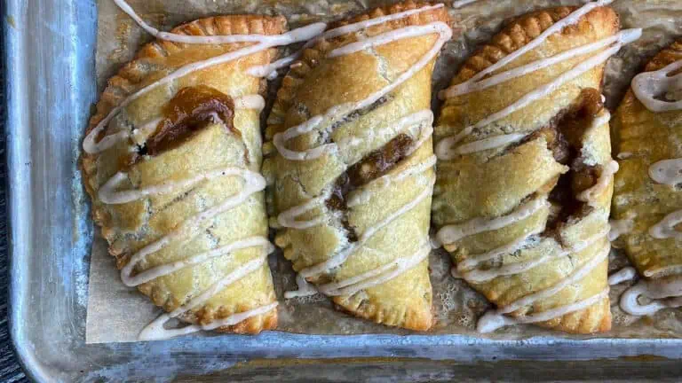 three hand pies with apples and covered in icing