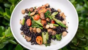 bowl of broccolini, tomatoes, black rice from Forbici Modern Italian