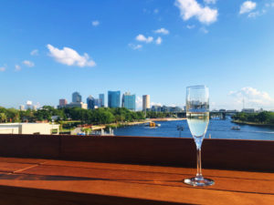 photo of a chamagne flut on a ledge at a rooftop bar