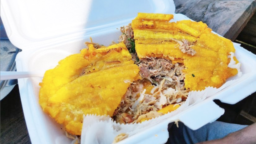 Photo of a pork sandwich with fried plantains as buns