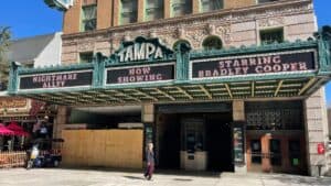 exterior of large theatre with green and yellow sign reading TAMPA