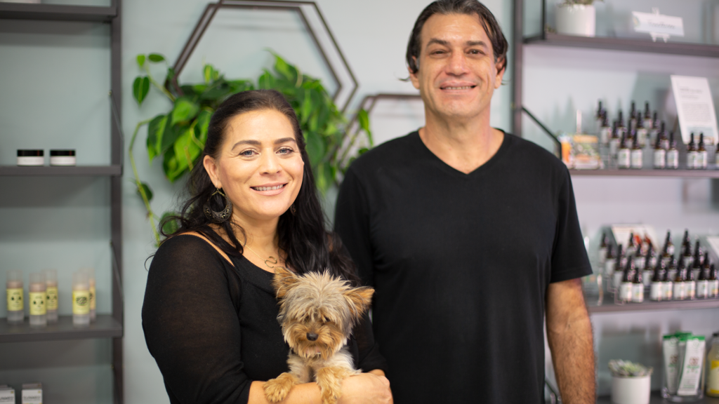CBD Store owners with their small dog in the store.