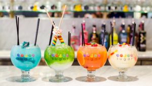 Photo of four brightly colored candy cocktails