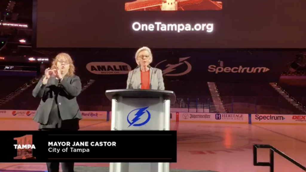 Tampa Mayor at a podium inside Amalie Arena