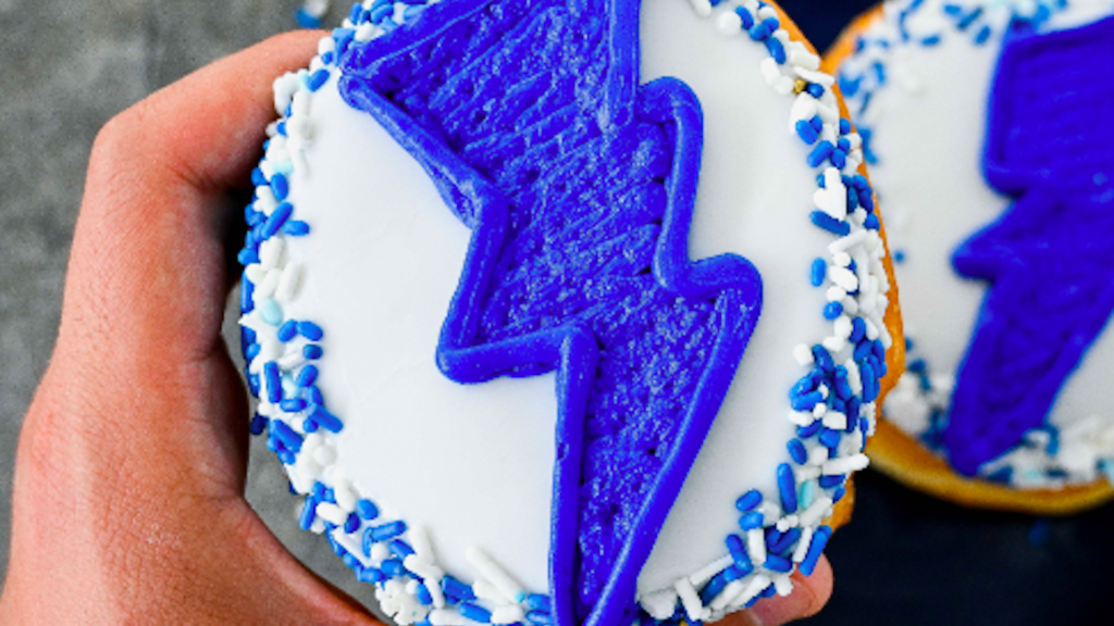 Phot of a vanilla froster donut with a blue lightning bolt on it