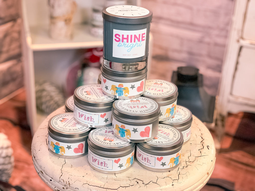 A stack of candles from seventh avenue apothecary with cute labels that say "wish" and "shine bright"