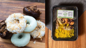 Donuts on a wooden board next to a prepackaged meal