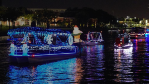 Photo of boats covered in holiday lights