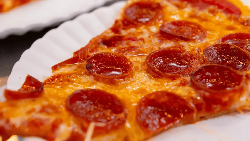 a slice of pizza with pepperoni on top