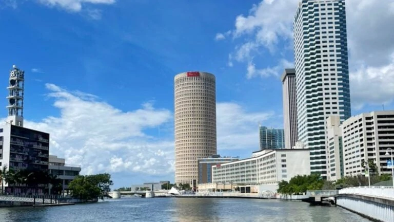 Hillsborough river with a tall cylindrical building in the background