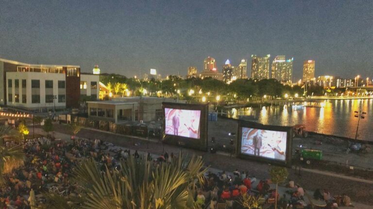 projector screen set up along a Riverwalk