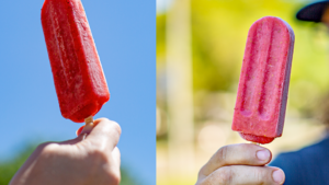 two pink popsicles being held up in the air
