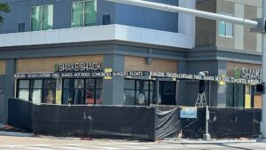 exterior of a ground floor shake shack with construction fencing around front