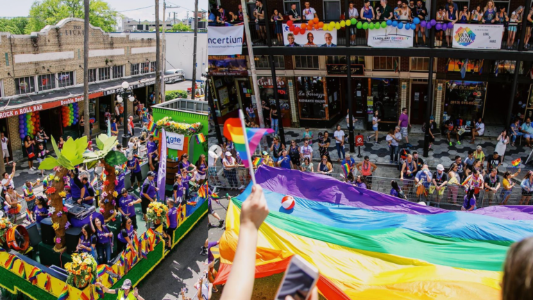 large rainbow flag being unfurled during a parade