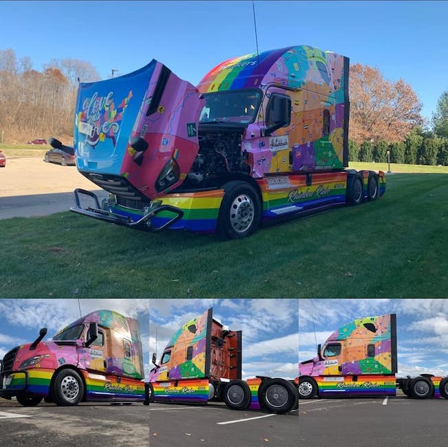 large truck with a rainbow design wrapped around it