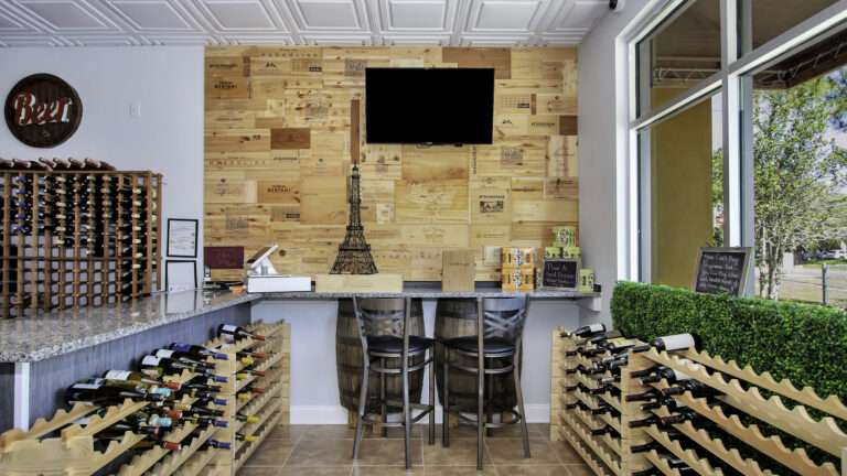interior of a wine bar with a green wall and wood paneling