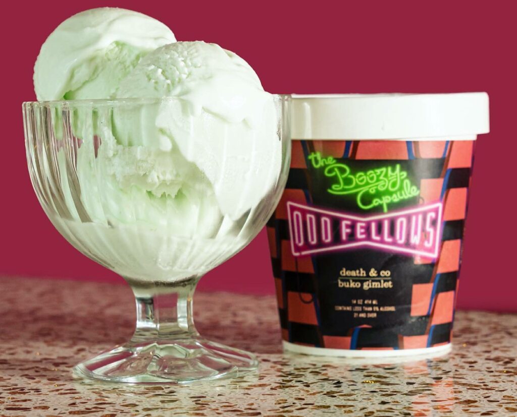 Photo of mint ice cream next to a black and red pint