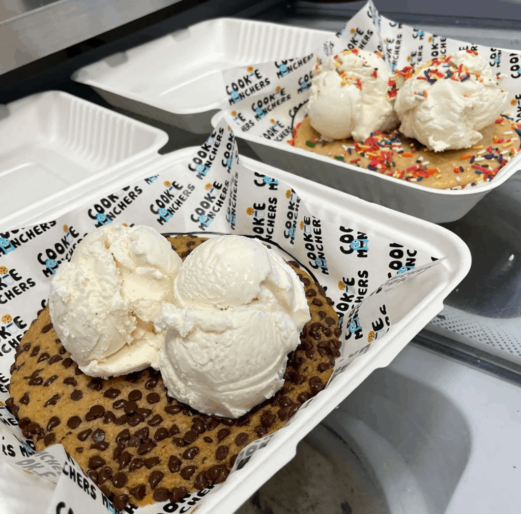 two plates of cookies with scoops of ice cream on each