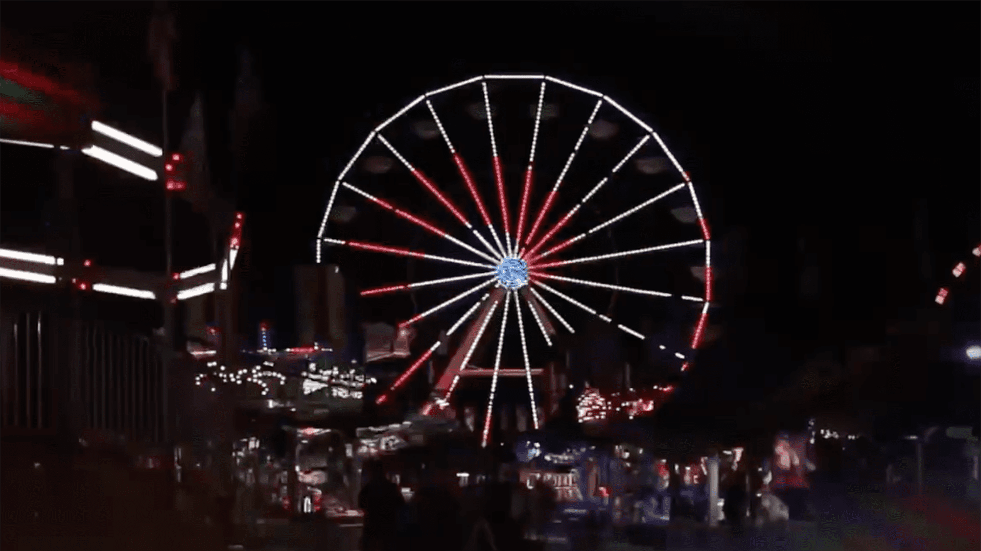 large Ferris wheel lit up at night