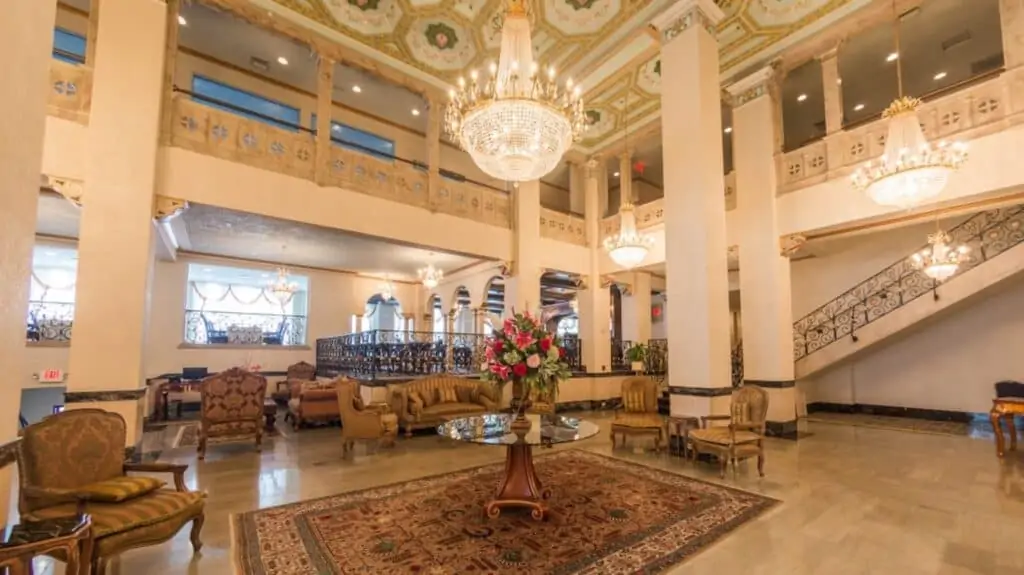 inside a hotel lobby with chandeliers