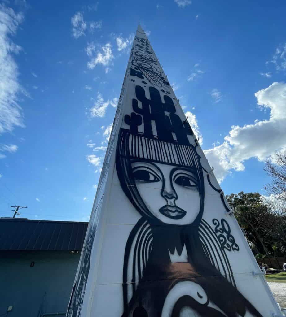 Tall steeple featuring black and white mural art