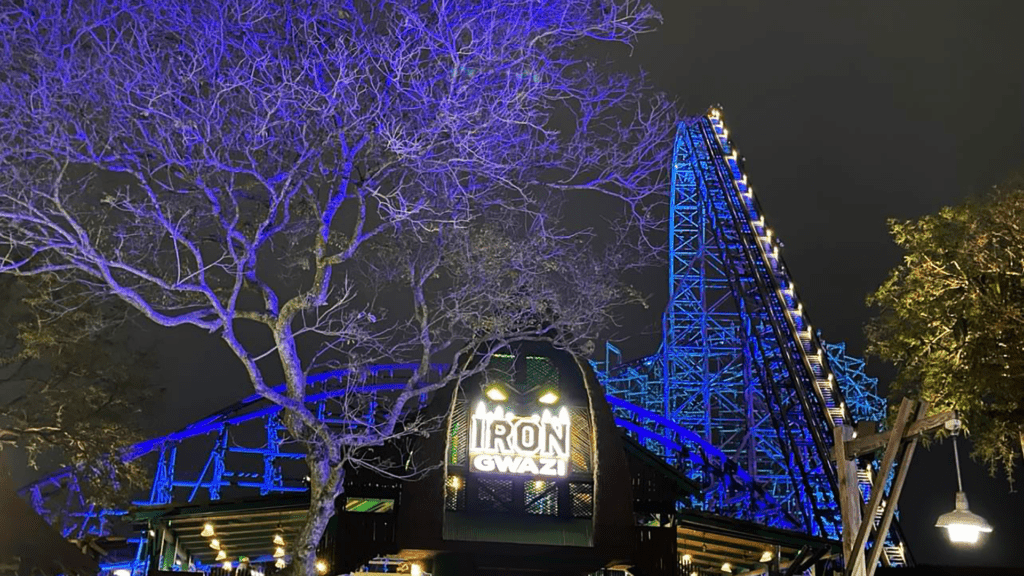 exterior of a giant roller coaster with blue lights on the tracks