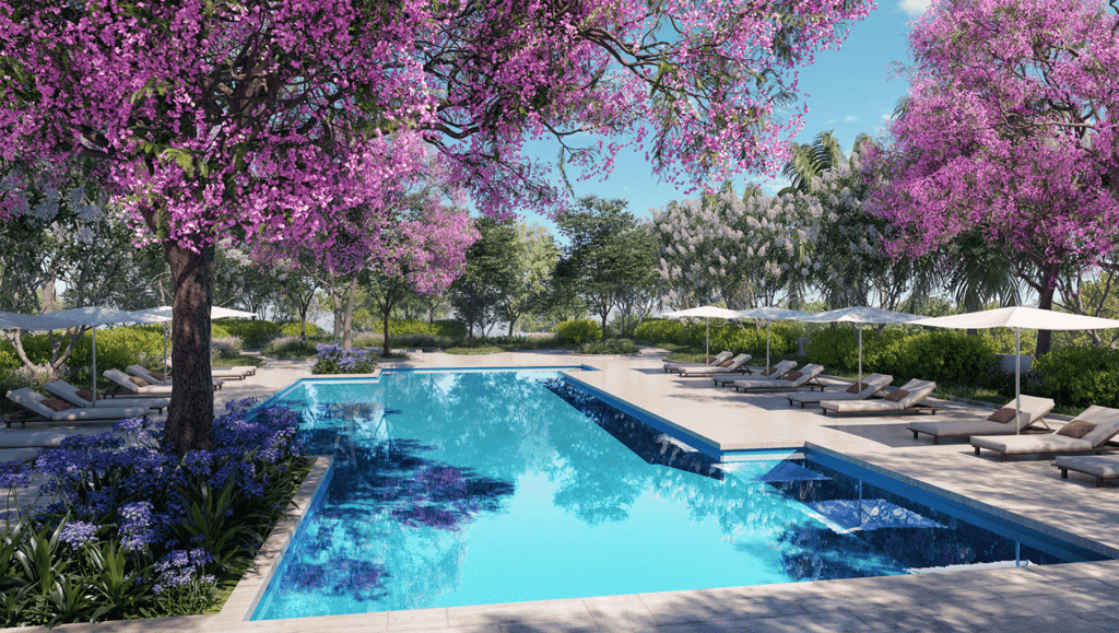 An in-ground pool surrounded by trees with pink blooms