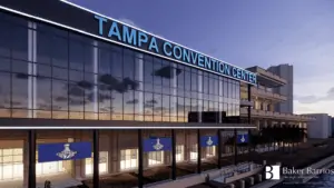 Rendering of a convention center. A glass facade faces a long riverwalk.