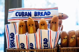 Felt art Cuban Breads with little smiley faces in the bread section at Tampa Fresh foods by Lucy Sparrow