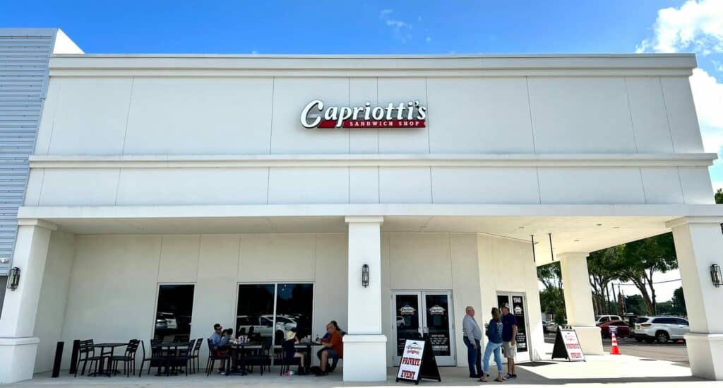 Exterior of a restaurant with a large sign that reads "Capriotti's" on the front