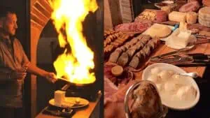 a pan with a large flame emerging from it. A long table covered in different plates of meat and cheese.