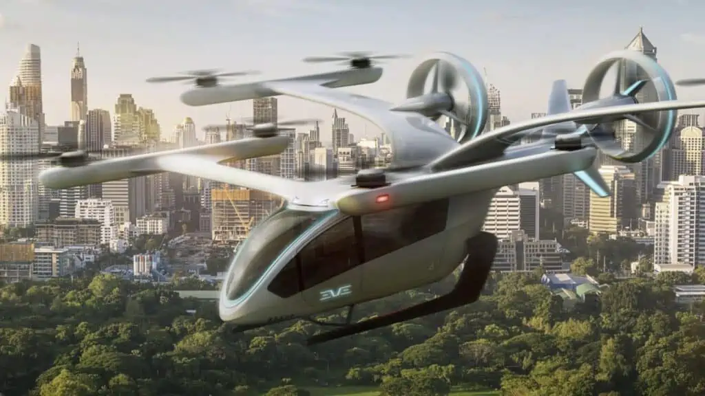 rendering of a electric airplane hovering over a city. It has 4 vertical propellers, with space for four passengers