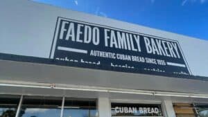 Exterior of a bakery with a black and white painted mural reading "Faedo Family"