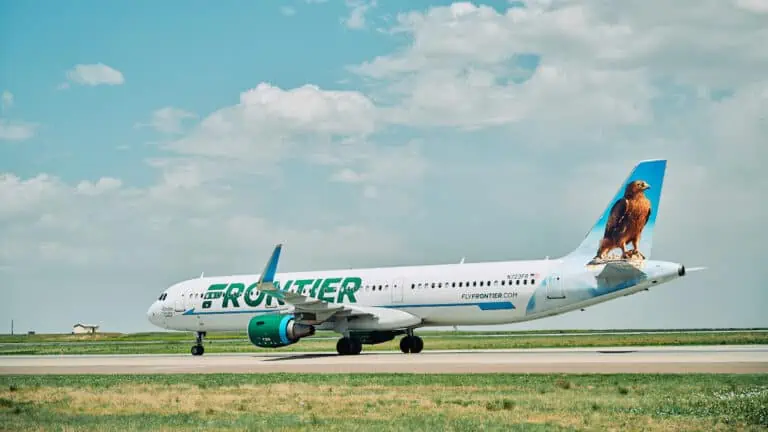 aircraft on a runway with green lettering on the side