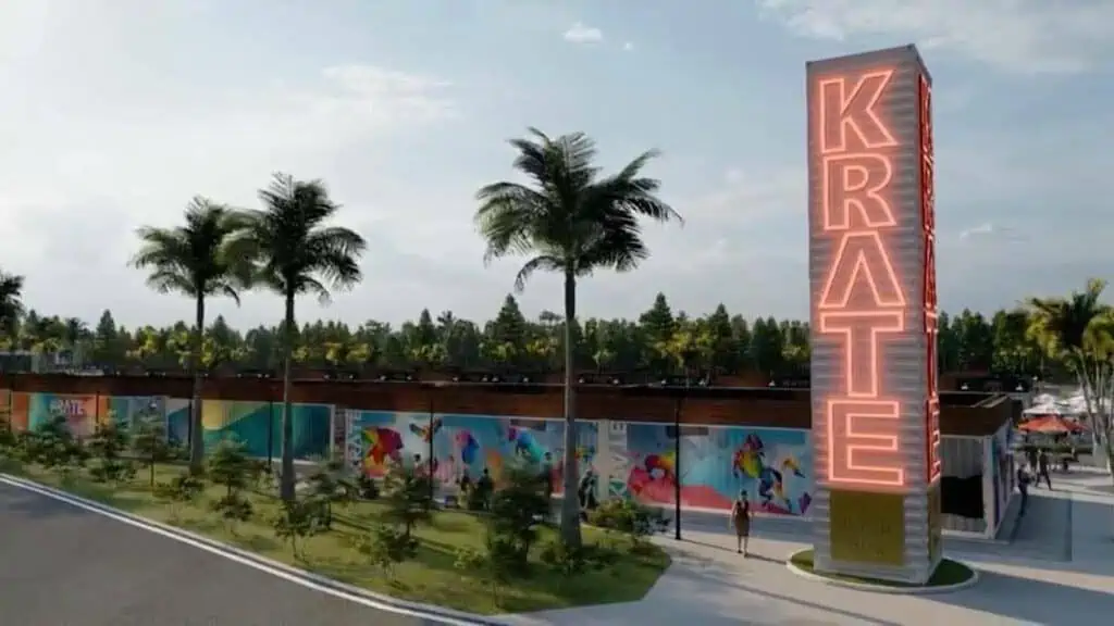 rendering of shipping containers with murals painted on them, and a tall neon sign that reads KRATE