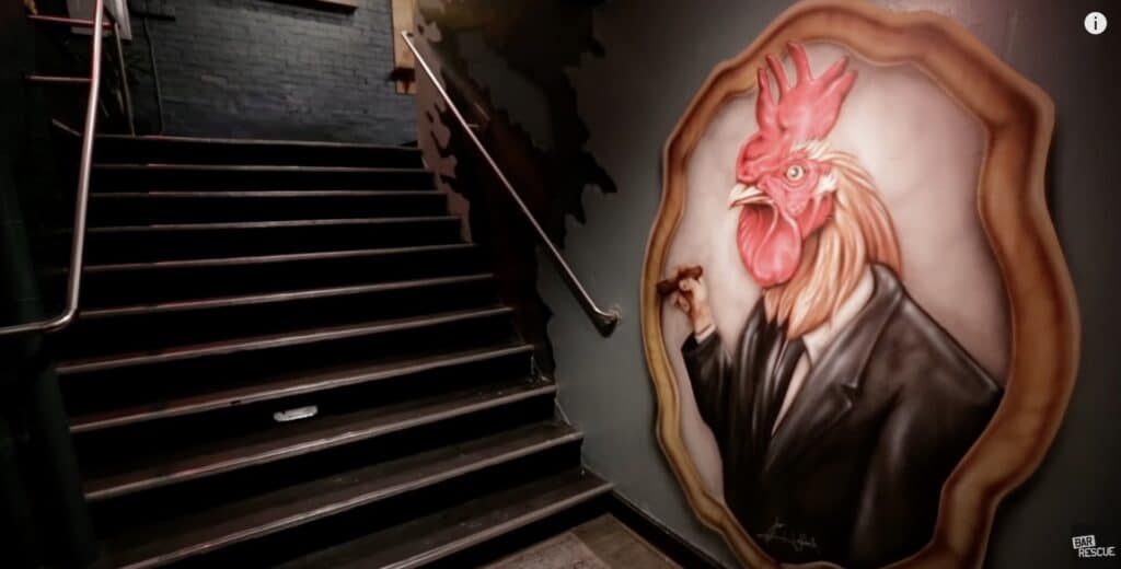 Mural of a rooster in a black and white suit at the entrance to a restaurant.
