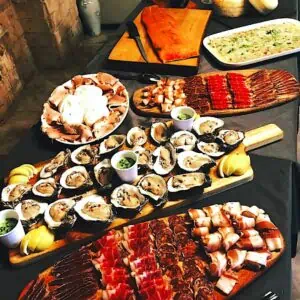 a selection of charcuterie, meats and cheeses, arranged of chic wooden boards.