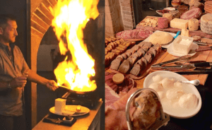 a pan with a large flame emerging from it. A long table covered in different plates of meat and cheese.