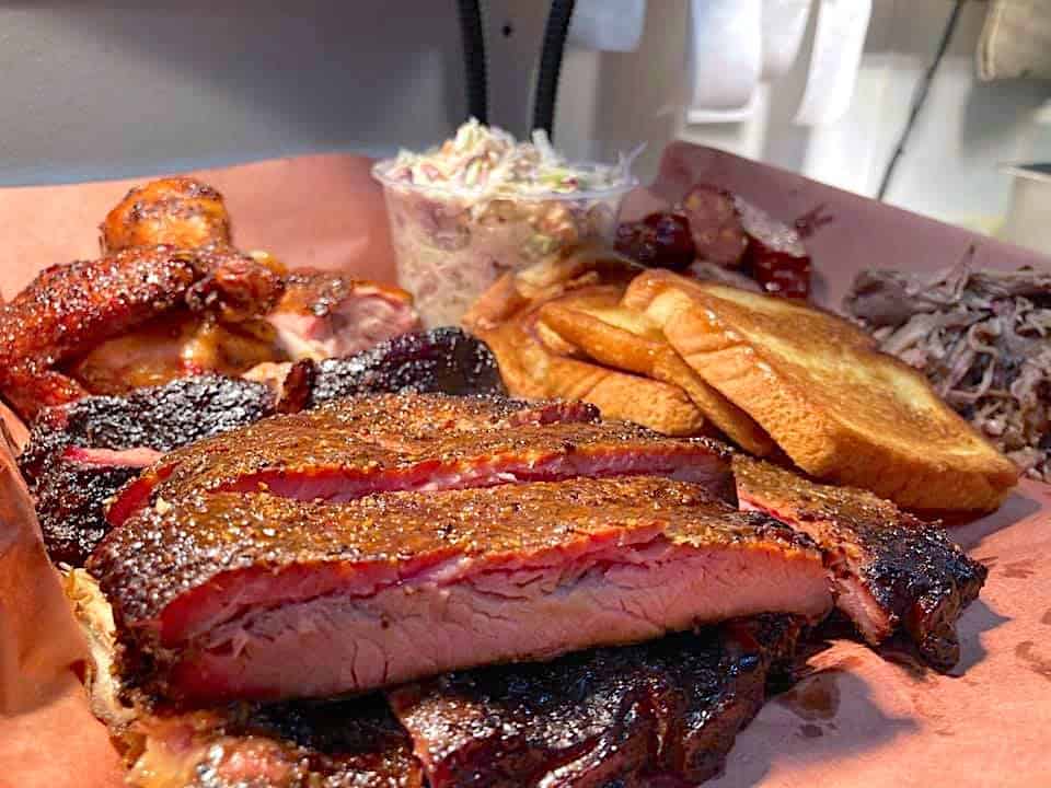 A plate of Texas toast with ribs arranged on a platter.