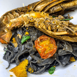 a plate of fried seafood over pasta