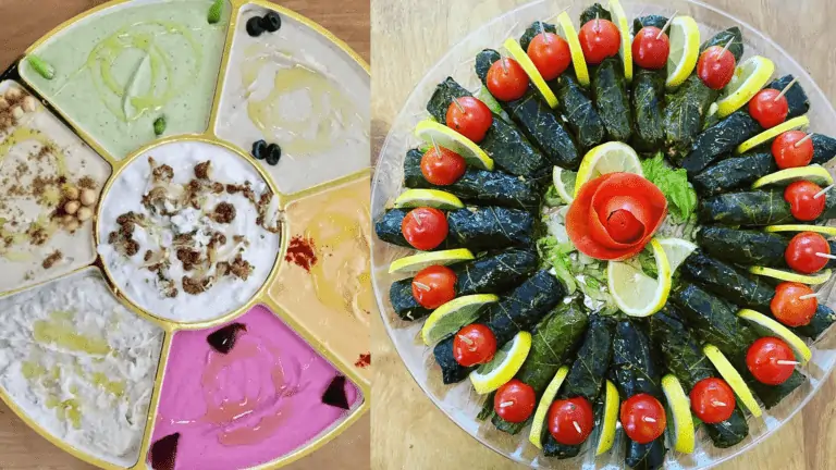 grapleaves with a bowl of hummus at the center with veggies cut to resemble flowers on top