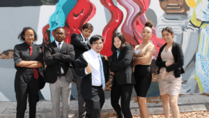 Anytown students in front of a mural