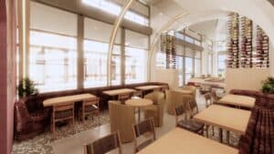 rendering of a restaurant interior with rows of booths next to a large window letting in natural light.