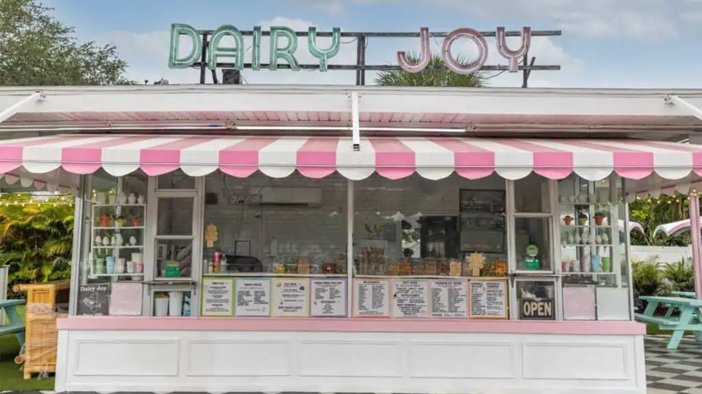 exterior of an ice cream parlor with a neon Dairy Joy sign on the front