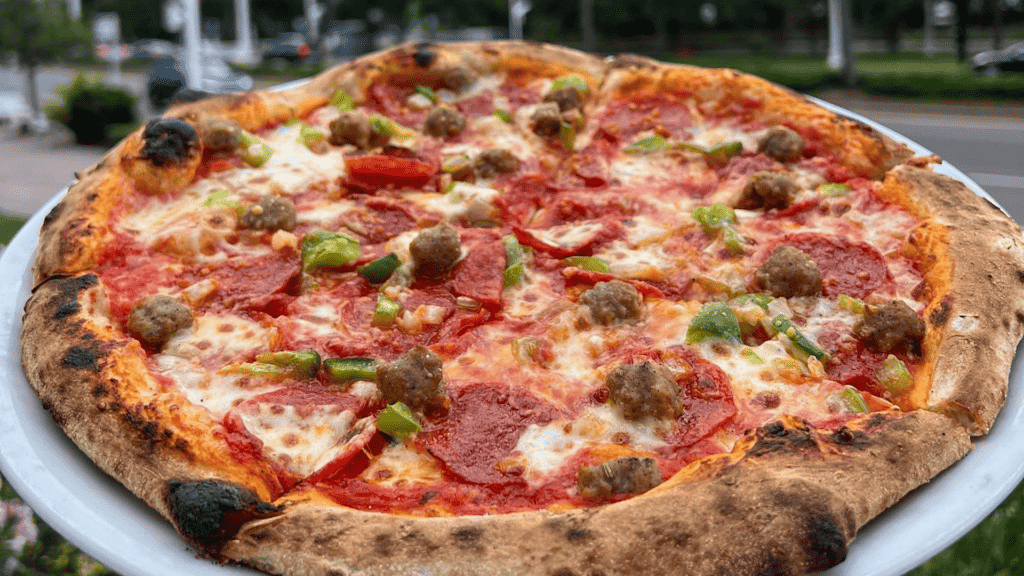 Pizza covered in red sauce and mozzarella cheese