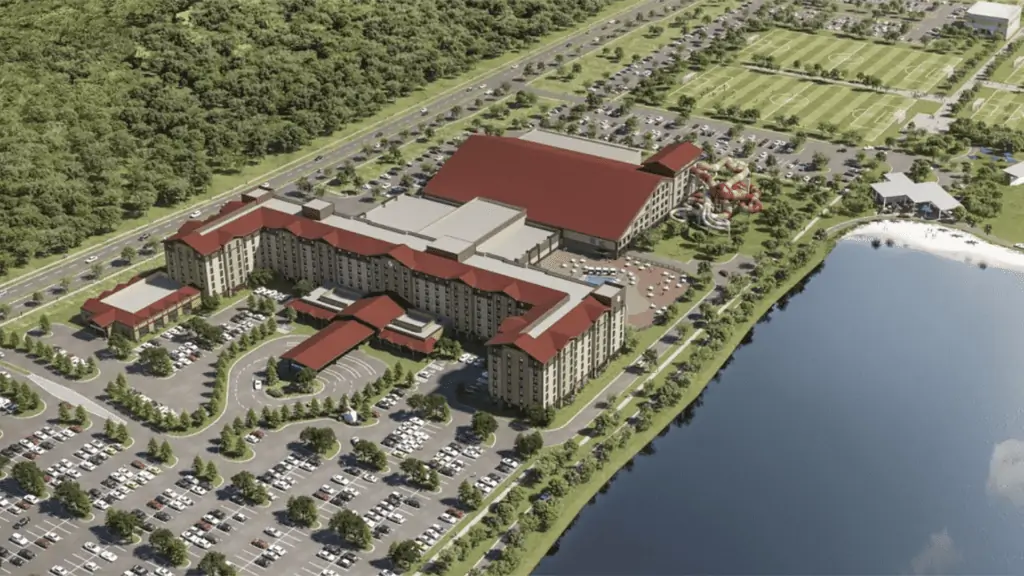 Rendering of a large lodge. A body of water is to the right. AA huge parking lot surrounds the entire facility.