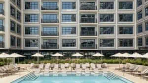 A hotel pool with several floors of units surrounding the pool