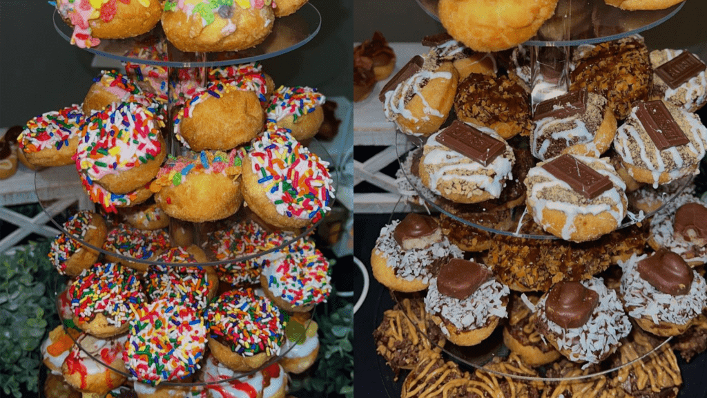 Two towers of local mini donuts. One features rainbow sprinkles, and the other is made of s'mores donuts.