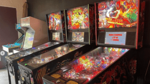 a row of pinball machines and arcade systems set up